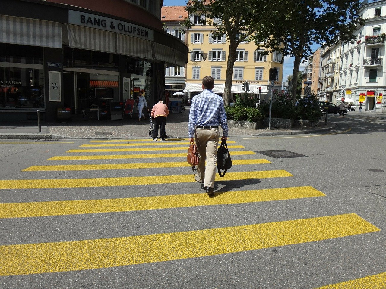 Pedestrian crossing road traffic sign showing a person on a zebra