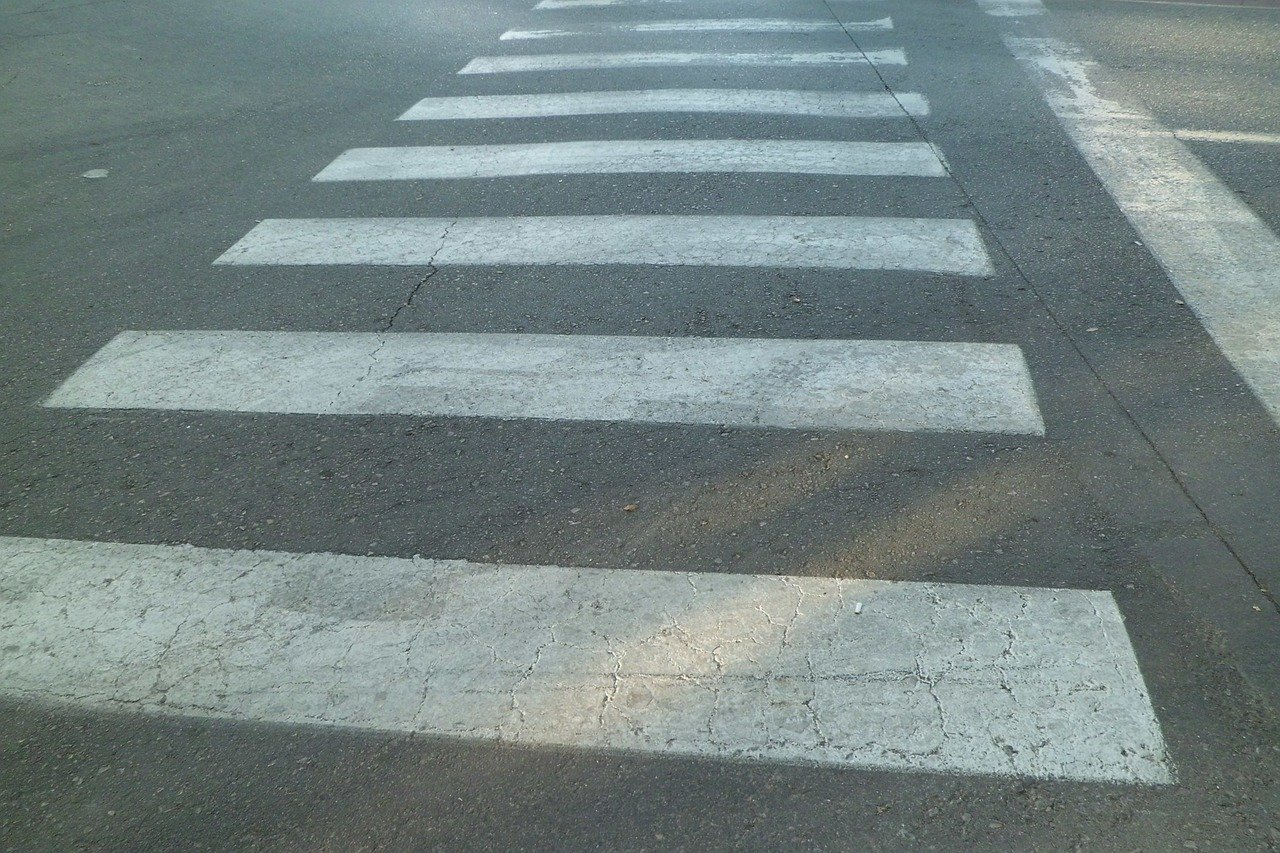 Pedestrian crossing road traffic sign showing a person on a zebra